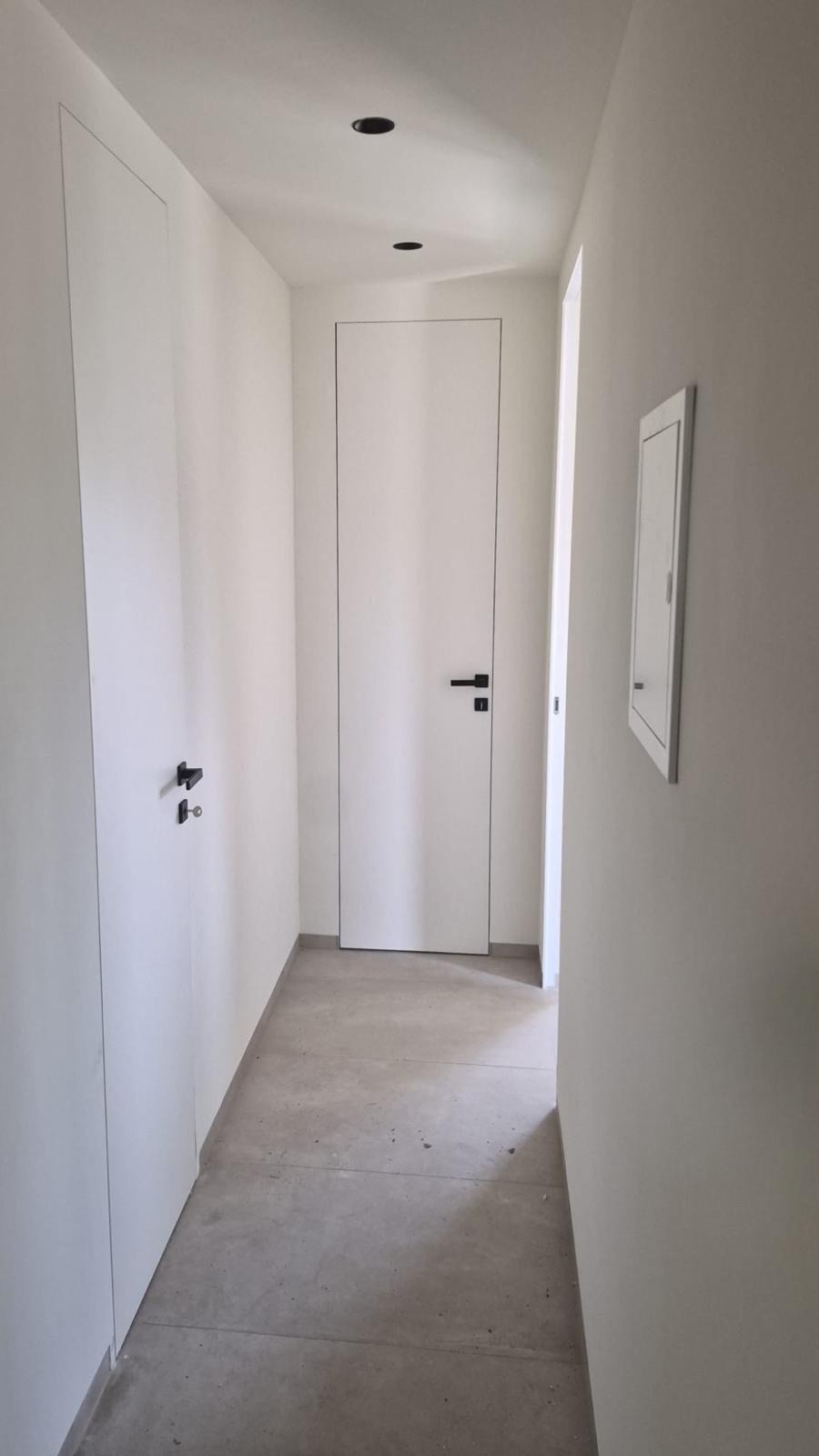 Minimalistička bijela vrata u uskom hodniku